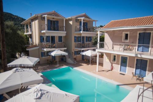 an aerial view of a villa with a swimming pool and umbrellas at Villa Theodora in Nikiana