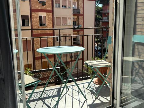 a table and two chairs on a balcony at Appartamento Onda in Lido di Ostia