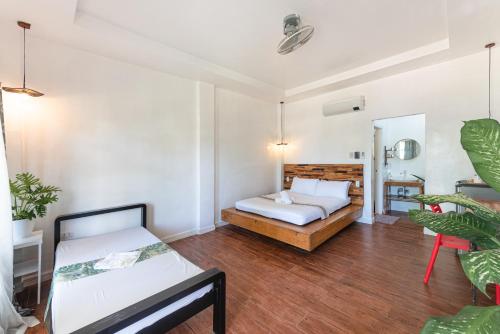 a bedroom with a bed and a chair in it at YAMA APARTMENTS - Private Beachfront in General Luna