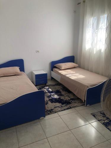 a bedroom with two beds and a window at Drams in Mezraya