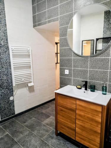 a bathroom with a sink and a mirror at F2 au cœur de Langeais. in Langeais