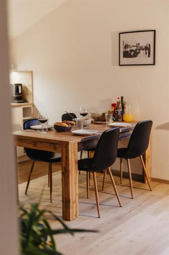 a dining room table with chairs around it at Chalupa Bezvětří in Malá Morávka