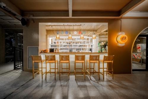 a bar with chairs and a counter in a room at Centara Life Lamai Resort Samui in Lamai