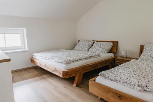 a bedroom with two beds and a window at Chalupa Bezvětří in Malá Morávka