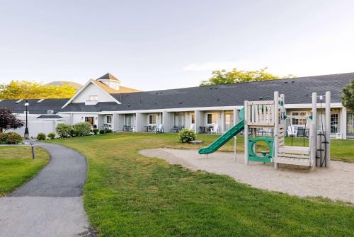 a playground in front of a building at Balcomo, a Ramada by Wyndham in Penticton