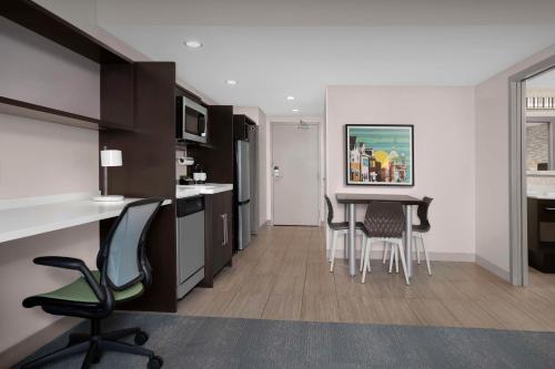 a kitchen and dining room with a table and chairs at Home2 Suites by Hilton Pittsburgh - McCandless, PA in McCandless Township