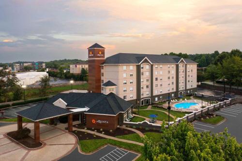 a large building with a clock tower on top of it at La Quinta by Wyndham Greensboro NC in Greensboro