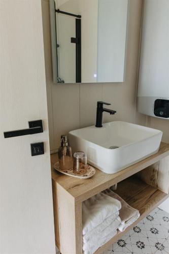 a bathroom with a white sink and a mirror at Chalupa Bezvětří in Malá Morávka