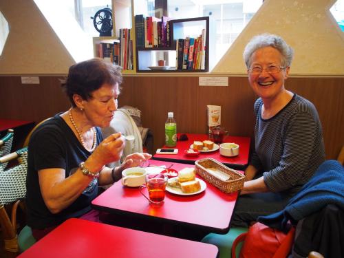 Due donne piu' grandi sedute a tavola a mangiare cibo di Sakura Hotel Hatagaya a Tokyo