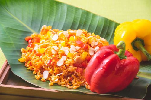 a plate of rice and peppers on a banana leaf at DoubleTree by Hilton Okinawa Chatan Resort in Chatan
