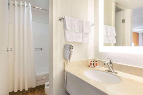 a bathroom with a sink and a phone at Howard Johnson by Wyndham Harrisonburg in Harrisonburg