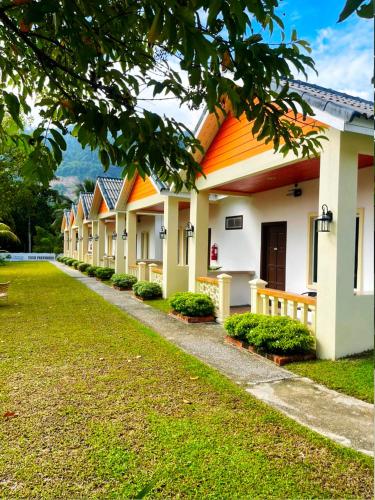 a row of houses with orange roofs in a park at Dreamz Village in Tanjung Rhu