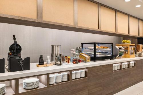 a kitchen with a counter with plates and food at Home2 Suites Livingston Yellowstone in Livingston