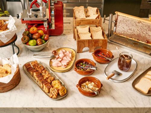 a table with different types of food on it at Novotel Melbourne Airport in Melbourne