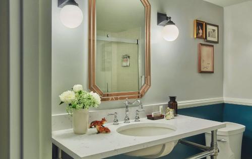 a bathroom with a sink and a mirror at Graduate by Hilton Charlottesville in Charlottesville