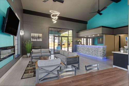 a living room with a couch and chairs at Baymont by Wyndham Branson Thousand Hills in Branson