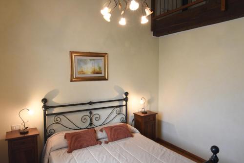 a bedroom with a bed with two night stands and two lamps at Agriturismo Villa Marta in Cesena