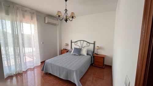 a bedroom with a bed and a chandelier at El Siprer in Anna