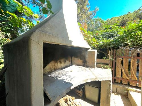 an outdoor pizza oven with its door open at Sea Breeze Home in Lotzorai