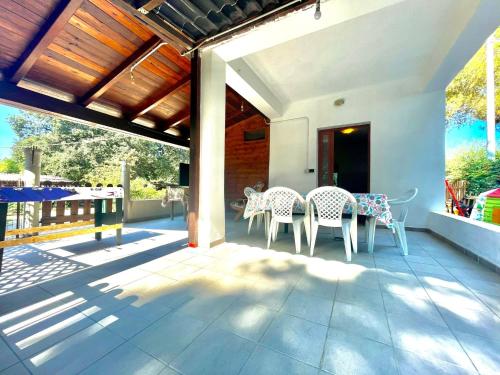 a patio with a table and chairs on it at Sea Breeze Home in Lotzorai