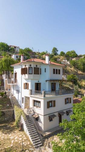 a white building with stairs leading up to it at Under Villa J in Katochori
