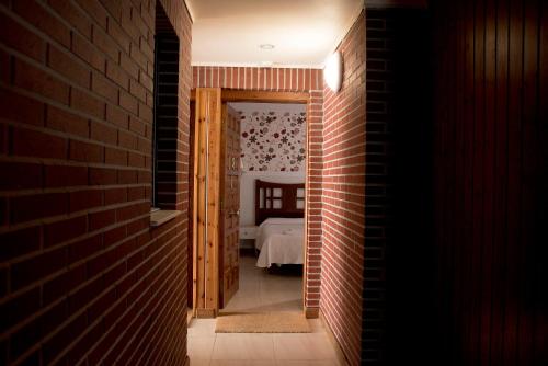a hallway leading to a bedroom with a bed at Hotel Ría de Suances in Suances