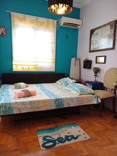 a bedroom with a bed in a room with a window at cozy διαμέρισμα με υπέροχη θέα ! in Athens