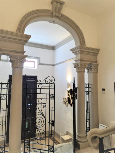 an archway with a wrought iron gate in a room at Allegra Viareggio Appartamento & Affittacamere Guest house in Viareggio