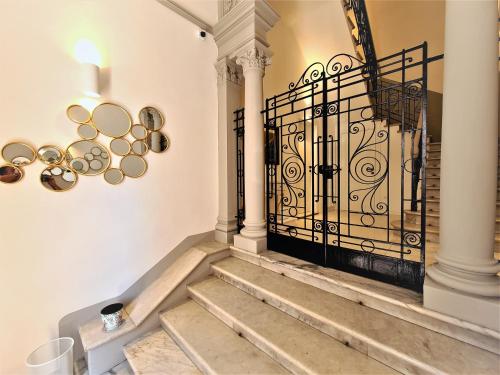 a staircase with a wrought iron gate in a house at Allegra Viareggio Appartamento & Affittacamere Guest house in Viareggio