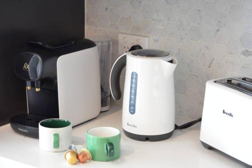 a counter with two toasters and a toaster and cups at Highrise Skyline Spectacular View Luxury 2B2B1C in Box Hill