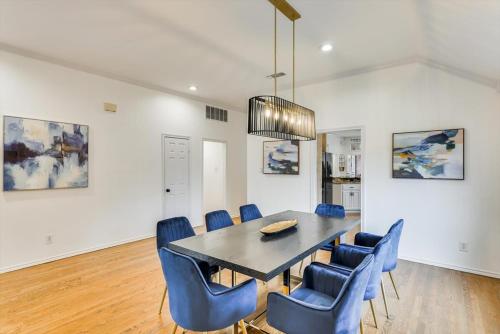 a dining room with a table and blue chairs at Impressive 5BR 3,5BA Holiday Home with Pool, Game Room & Cinema Room in Irving