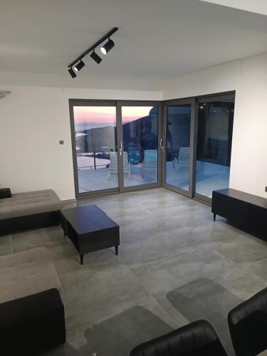a living room with a couch and a table at Holiday House "M" Omiš - Newly renovated house with swimming pool, 3 rooms, gym, large terrace with amazing view on town and 6 parkplaces in Omiš