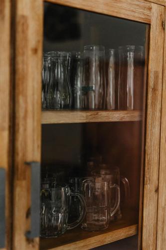 a cabinet filled with glass mason jars at Chalupa Bezvětří in Malá Morávka