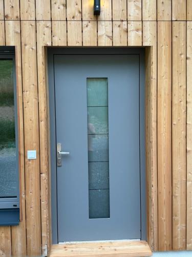 a blue door in a wooden building at Bergchalet mit Panoramablick Diex in Diex