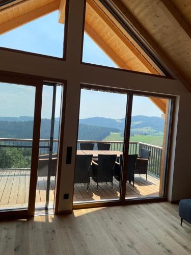 a view from the living room of a house with large windows at Bergchalet mit Panoramablick Diex in Diex