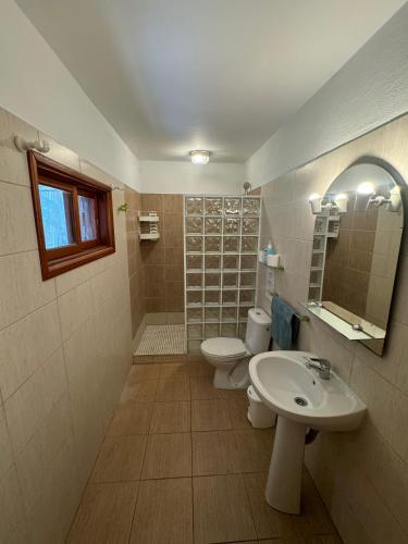 a bathroom with a toilet and a sink at Finca Gerardo Miramar in La Playa Calera