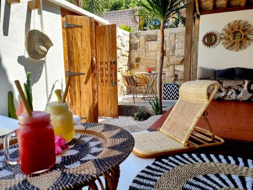 a patio with a table and chairs on a patio at Kaleydo Villas in Gili Trawangan