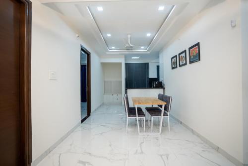a dining room with a table and chairs at The Balcony Suites in Hyderabad