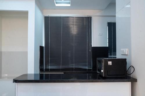 a microwave sitting on a counter in a kitchen at The Balcony Suites in Hyderabad