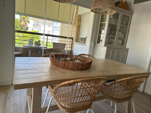 a kitchen with a wooden table with baskets on it at Vivienda de lujo a 100 metros de la playa in La Antilla