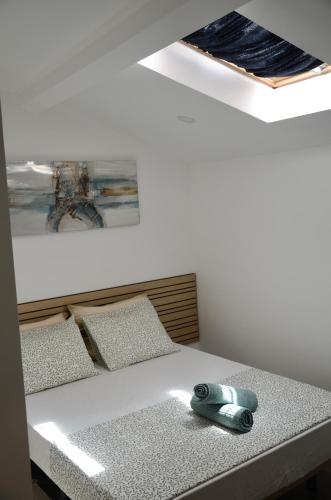 a bed with a phone sitting on top of it at RIA Terrace in Faro