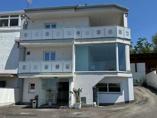 a large white building with a balcony on it at Hotel Cocceio in Bacoli