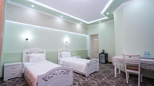 Postel nebo postele na pokoji v ubytování Mahruz HOTEL