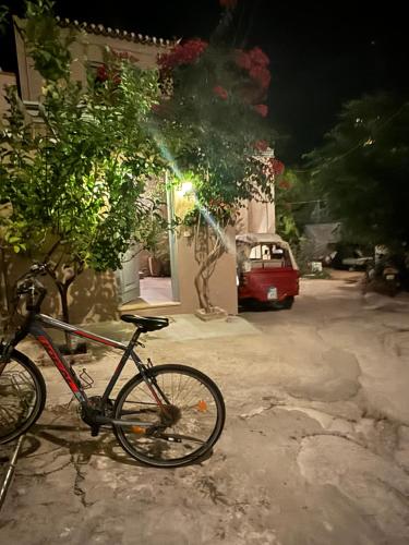 a bike parked on the side of a street at night at villa aneme Spetses in Spetses