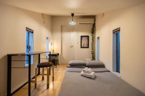 a room with two beds and a desk in it at HAN'S EBISU - Shibuya - Entire House for Max 10 ppl in Tokyo