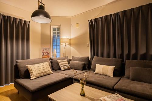 a living room with a couch and a table at HAN'S EBISU - Shibuya - Entire House for Max 10 ppl in Tokyo