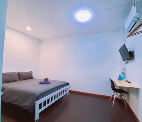 a room with a bed and a desk with a computer at Bangkok Cozy Home @Khaosan Road in Bangkok