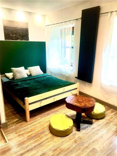 a bedroom with a bed and a table in it at Wałbrzych blisko Teatru in Wałbrzych