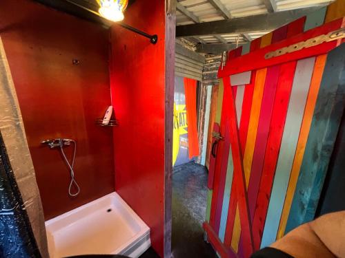 a bathroom with a shower and a toilet in a room at Gypsy Camp Apartments & Glamping in Liepāja