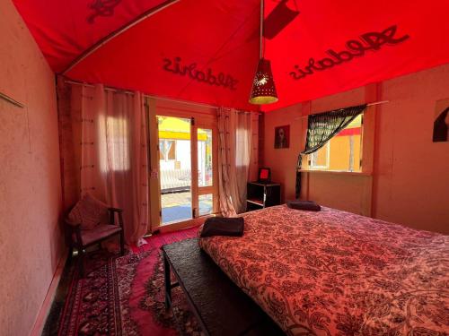 a red bedroom with a bed in a room at Gypsy Camp Apartments & Glamping in Liepāja